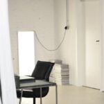 Professional Meeting - Interior of spacious loft studio with meeting table and chairs surrounded by hanging white curtains