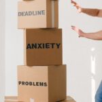 Ethical Decision - Man near carton boxes with many different words about stress