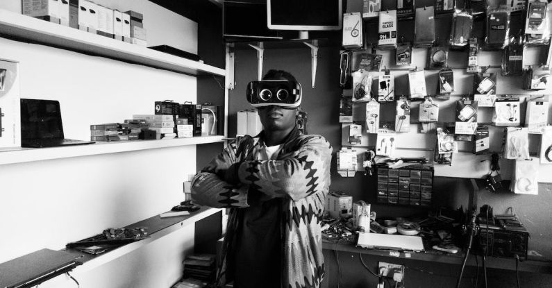 Customer Experience - Black man in VR goggles in electronics store