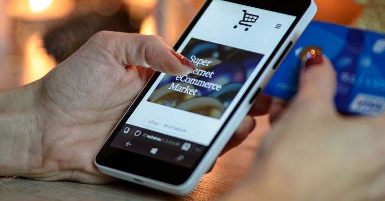 E-commerce Website - Person Using Black And White Smartphone and Holding Blue Card