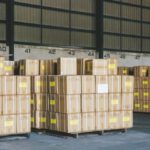 E-commerce Logistics - Industrial warehouse filled with a vast array of boxes, freight and shipping materials for distribution and transportation.
