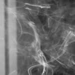 Habit Productivity - Cigarette smoke floating in dark room