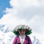 Cloud Solutions - A woman in a traditional dress stands in front of mountains