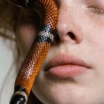 Overcoming Adversity - Close-Up Photo of a Woman Overcoming Her Fear of Snakes
